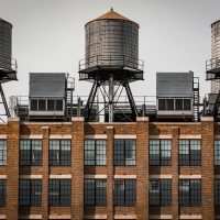 Iconic water towers on a New York City rooftop, showcasing urban architecture.
