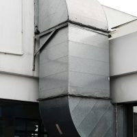 Close-up of a contemporary ventilation duct exterior in a city setting.