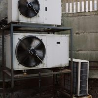 Industrial air conditioning unit stacked outdoors with metallic structure.