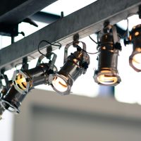 Electrical Services Modern industrial spotlights mounted on a ceiling providing focused illumination.